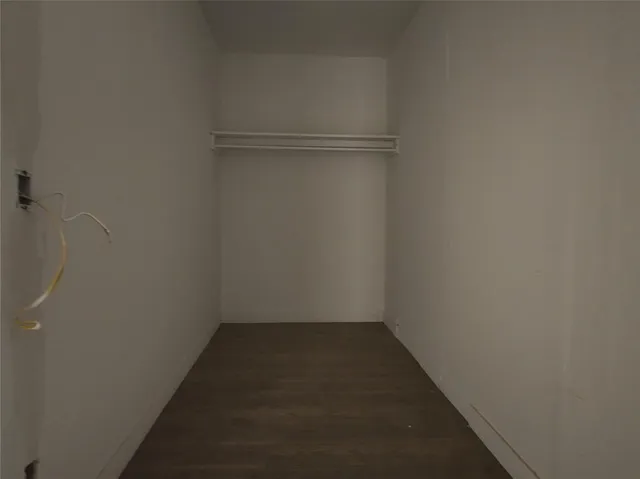 a view of a kitchen with wooden floor and electronic appliances