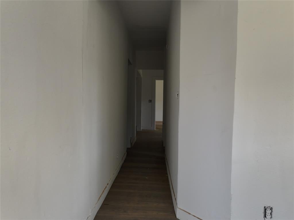 1428 Texas Street Vernon, TX 76384 - Photo 23 of 30 a view of a hallway with a wooden floor