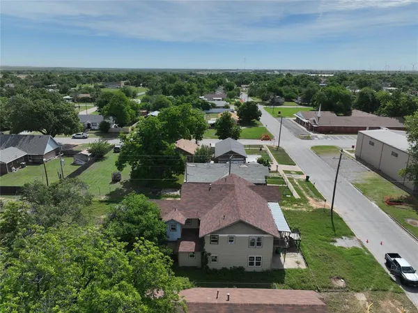 an aerial view of residential houses with outdoor space