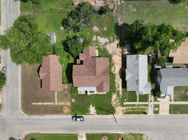 an aerial view of residential houses with outdoor space and parking