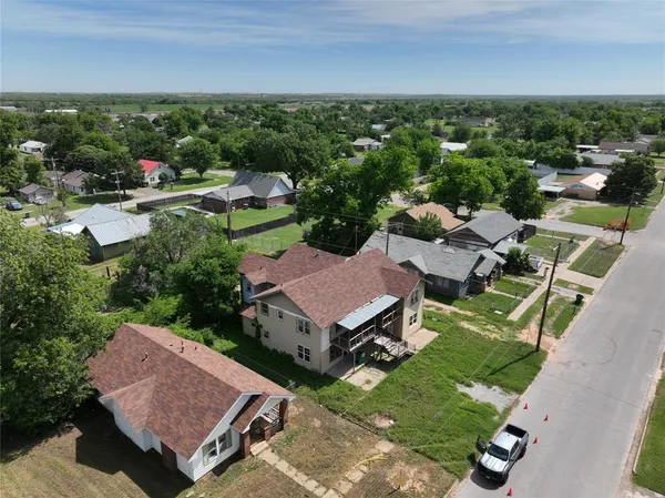 an aerial view of a house with garden space and street view