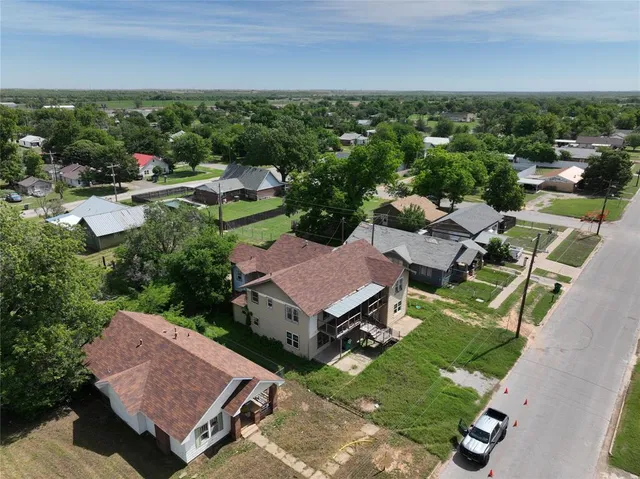 an aerial view of a house with garden space and street view