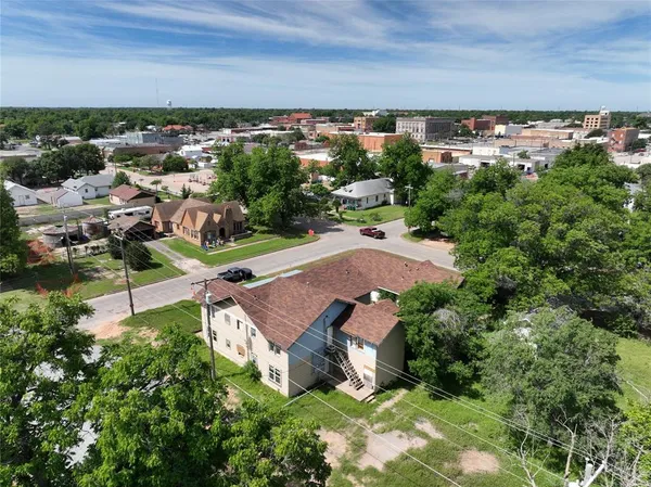 an aerial view of a house with a yard and lake view