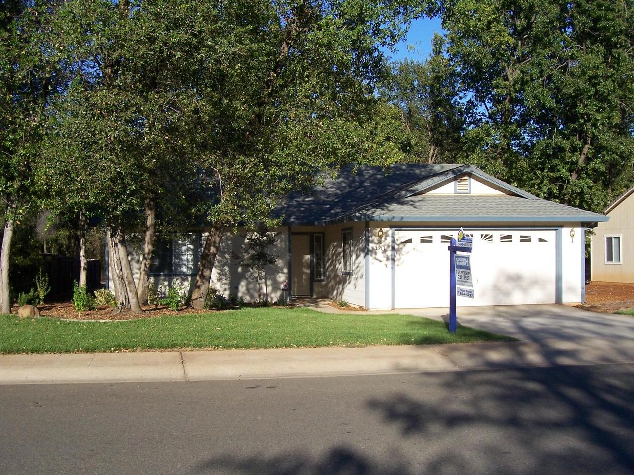 3351 Lawrence Road Redding, CA 96002 - Photo 1 of 8 a front view of a house with a yard and garage