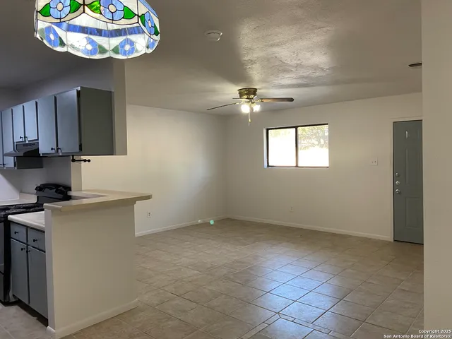 a kitchen with kitchen island granite countertop stainless steel appliances a stove a sink a microwave and cabinets