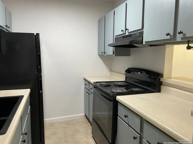 a kitchen with stainless steel appliances granite countertop a stove and a microwave