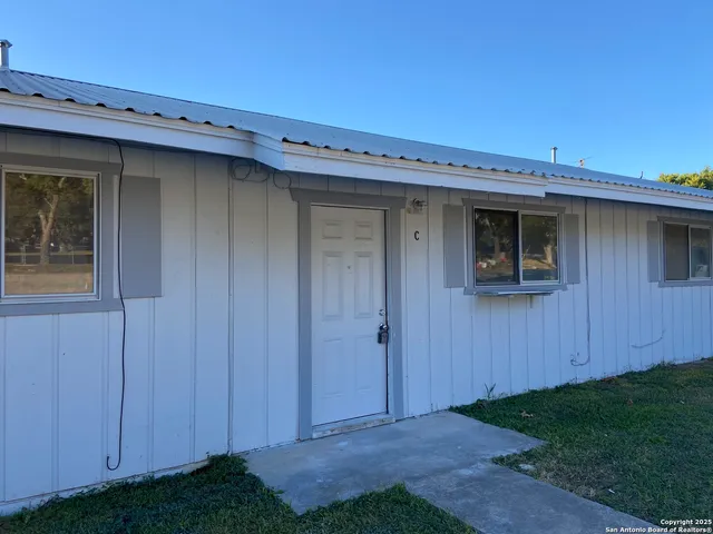 a view of a house with a backyard