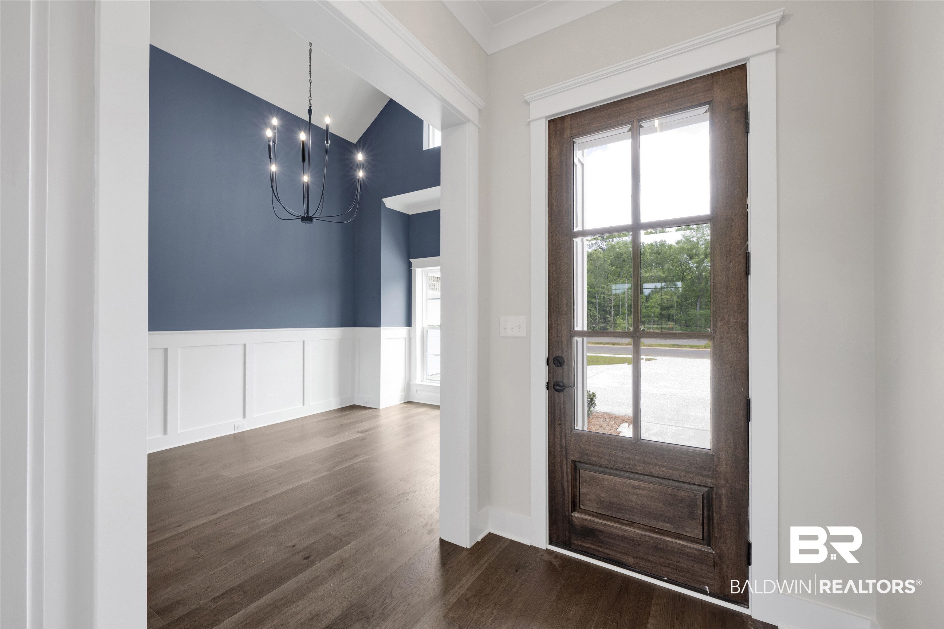 27315 Patch Pl Loop Daphne, AL 36526 - Photo 5 of 43 Entrance foyer with a chandelier, wood floors, wainscoting, lofted ceiling, and a decorative wall