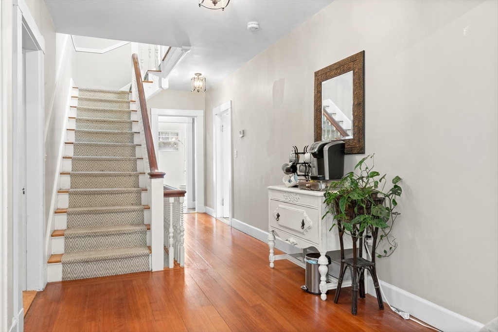 9 Winthrop Street Danvers, MA 01923 - Photo 29 of 41 a view of a hallway with wooden floor and a potted plant