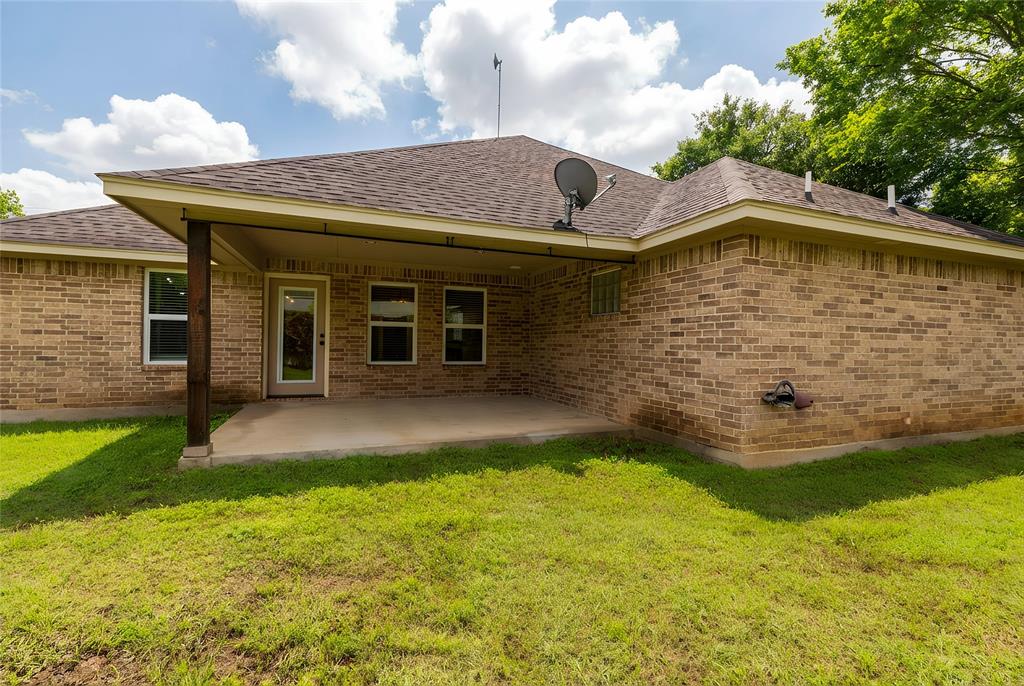 405 Kimbrough Road Azle, TX 76020 - Photo 28 of 39 a backyard of a house with a yard and garage