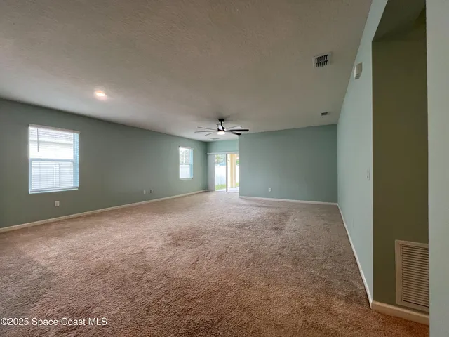 a large kitchen with stainless steel appliances kitchen island granite countertop a refrigerator and a sink
