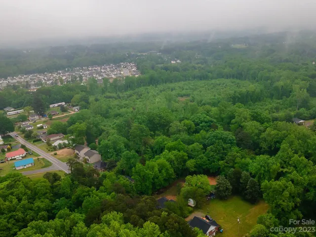 an aerial view of a houses with yard