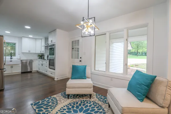 a large kitchen with a white stove top oven and refrigerator