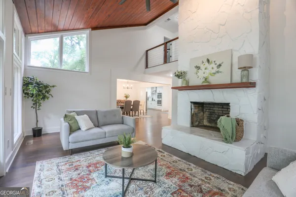 a living room with furniture and a chandelier