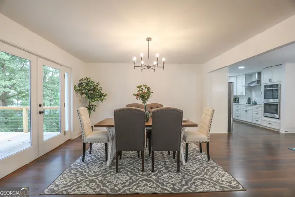 a bed sitting in a spacious bedroom next to a window