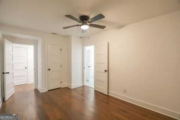 an empty room with fireplace and fan