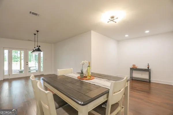 an aerial view of a residential houses with outdoor space and lake view