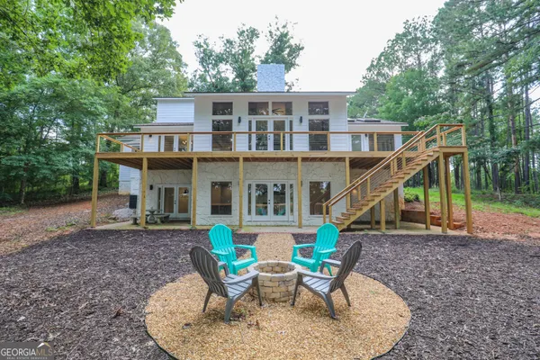 a view of a house with a yard and sitting space