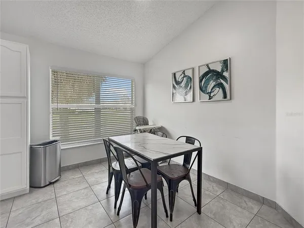 a view of a room that has a table and chairs in it
