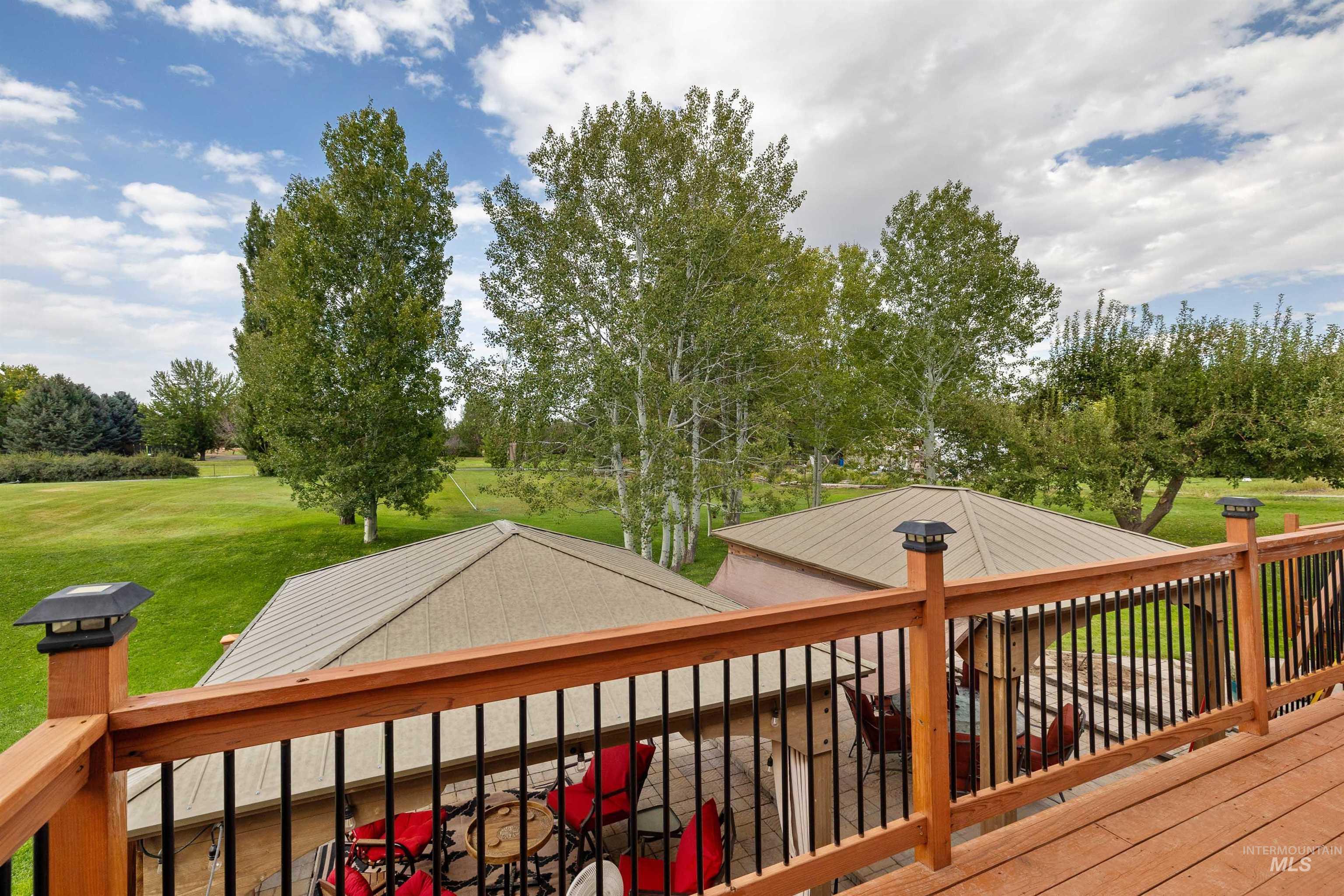 216 Ranch View Road West Jerome, ID 83338 - Photo 26 of 42 Wood-finish deck with black metal balusters and post cap lighting