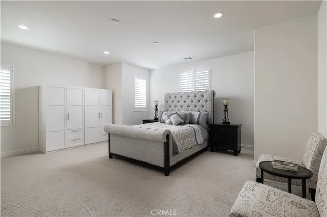 a spacious bedroom with a bed and a window