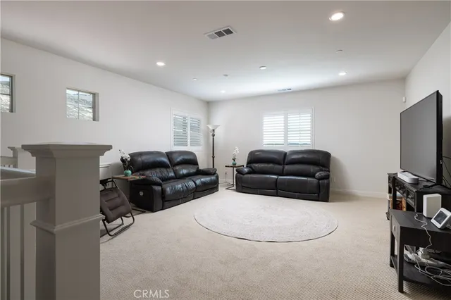 a room with furniture a flat screen tv and a window