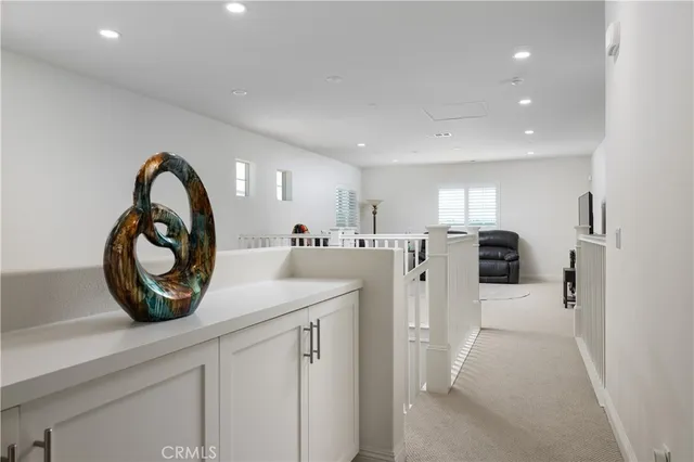 a view of a kitchen with refrigerator and white cabinets