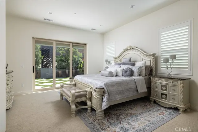 a bedroom with a bed chair and a large window