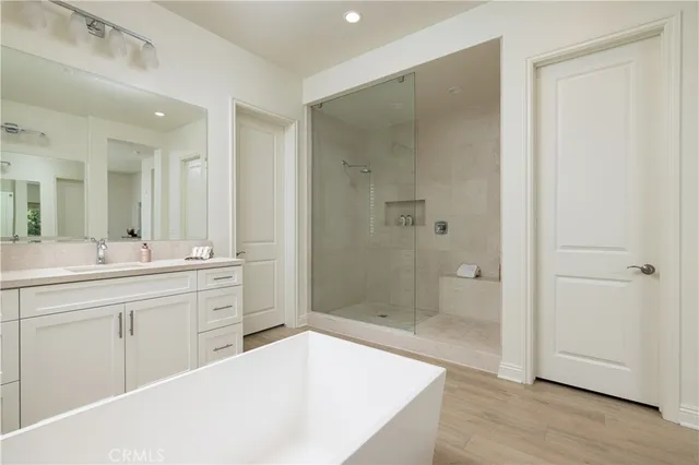 a spacious bathroom with a shower sink and mirror