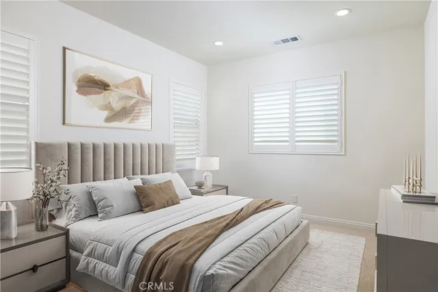 a bedroom with a bed and a painting on the wall