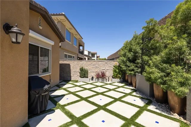 a view of a backyard both side of the house