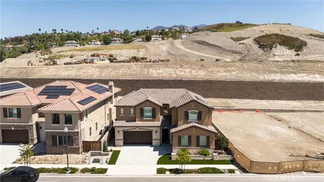 an aerial view of residential houses with city view