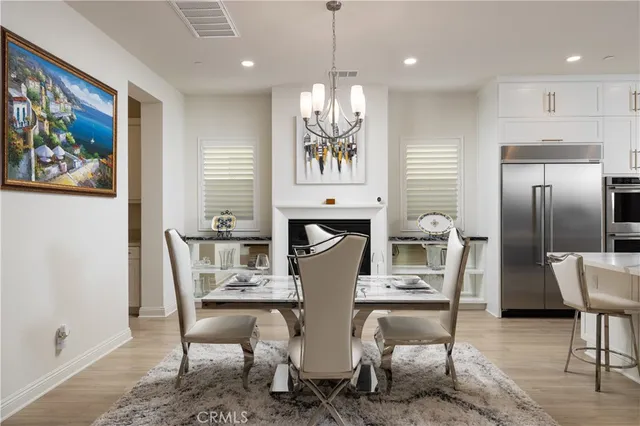 a view of a dining room with furniture a chandelier and wooden floor