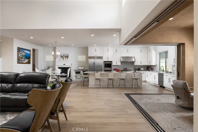a living room with furniture and kitchen view