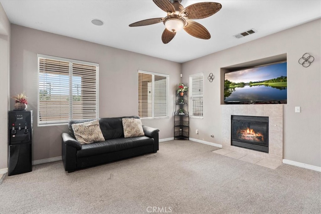 1474 Albillo Loop Perris, CA 92571 - Photo 7 of 35 a living room with furniture and a fireplace