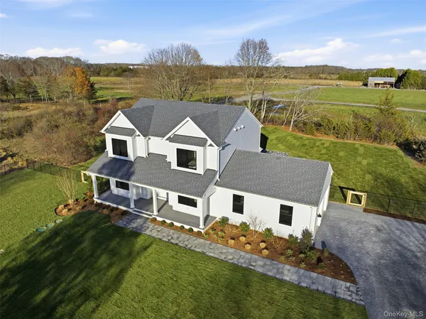 an aerial view of a house with big yard