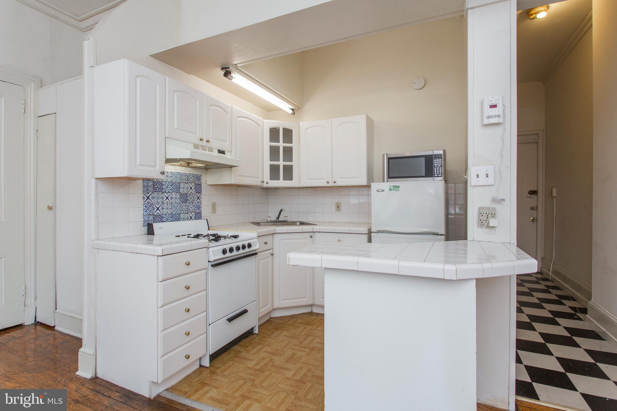 1807 Spruce Street, Unit 2F Philadelphia, PA 19103 - Photo 5 of 17 a kitchen with stainless steel appliances a stove a sink and a refrigerator