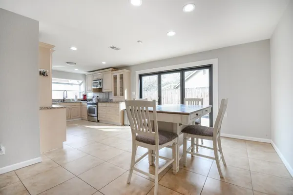a kitchen with a table and chairs