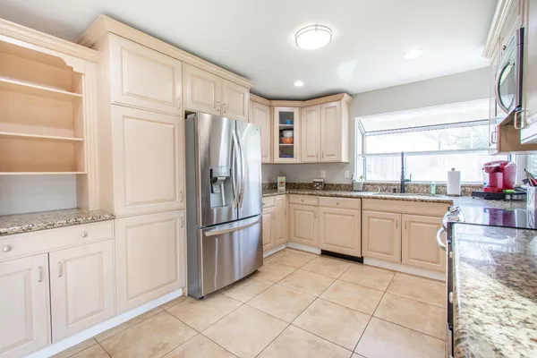 a kitchen with granite countertop cabinets and steel stainless steel appliances
