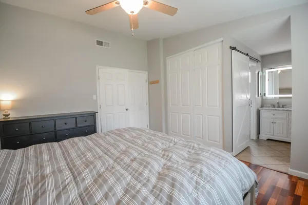 a bedroom with a bed and a chandelier