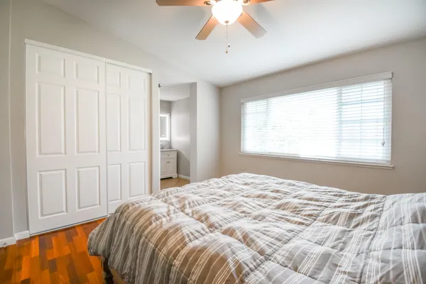a bedroom with a bed and a window