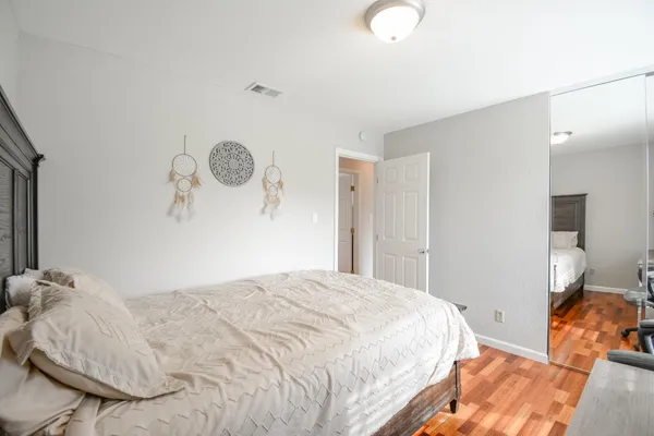 a bedroom with a bed and a lamp
