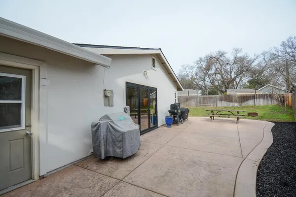 a view of a house with garage and couches
