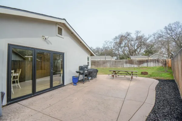 a view of a house with backyard and sitting area