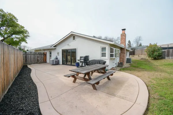 a view of a house with backyard and sitting area