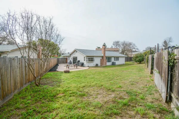 a aerial view of a house with yard and deck
