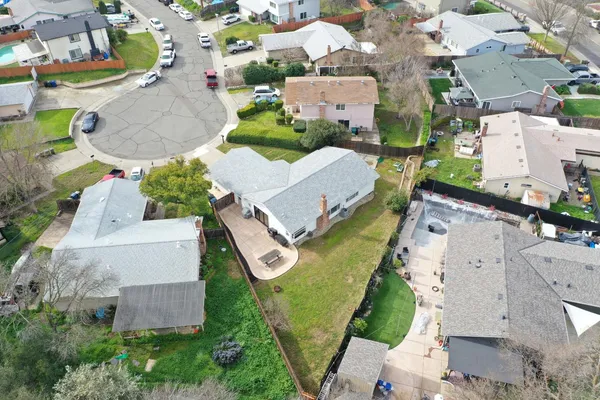 an aerial view of multiple houses with yard