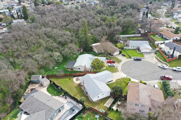 an aerial view of a house with garden space and street view