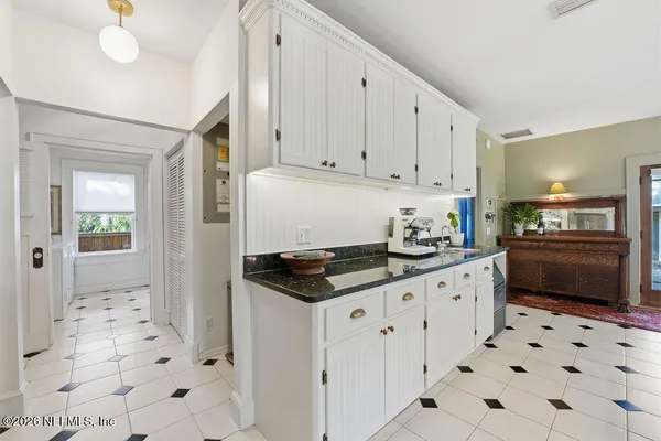a large kitchen with a table and chairs