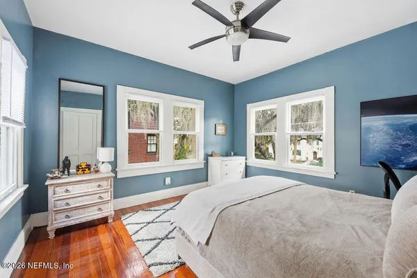 a living room with furniture a chandelier and a large window